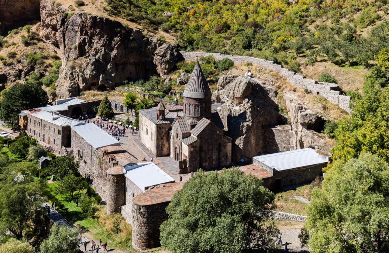 Geghard Monastery in Armenia surrounded by rocky mountains