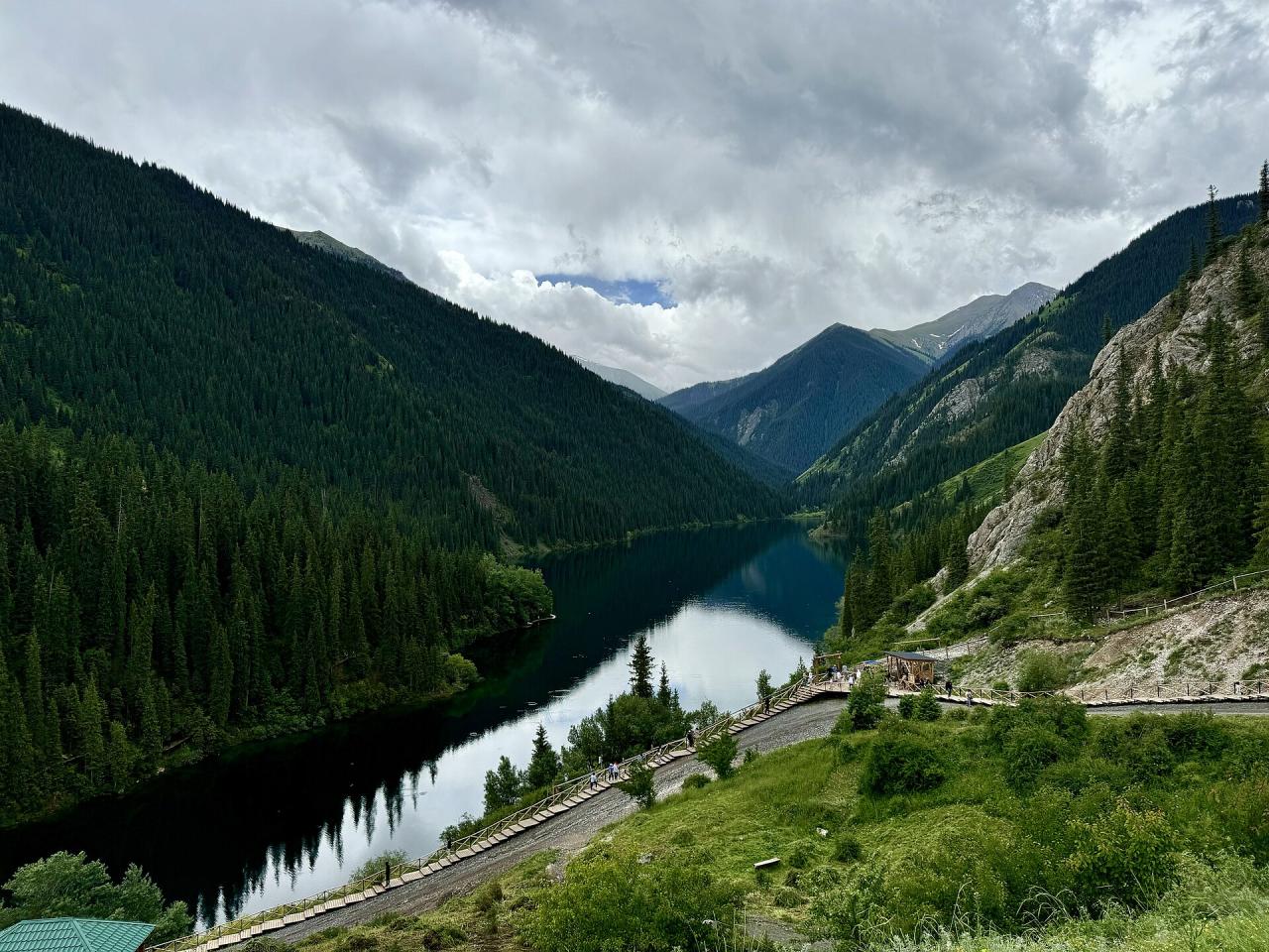 Lower Kolsai Lake surrounded by steep forested mountains in Kazakhstan
