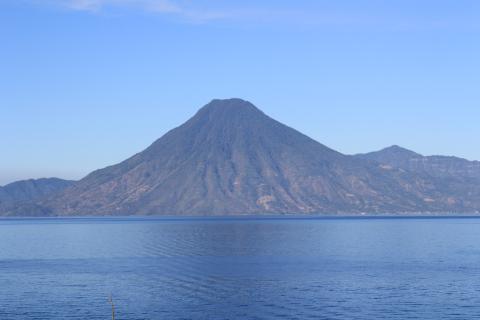 Lake Atitlan on a calm morning with the cone of Volcan San Pedro rising directly across the water from Panajachel