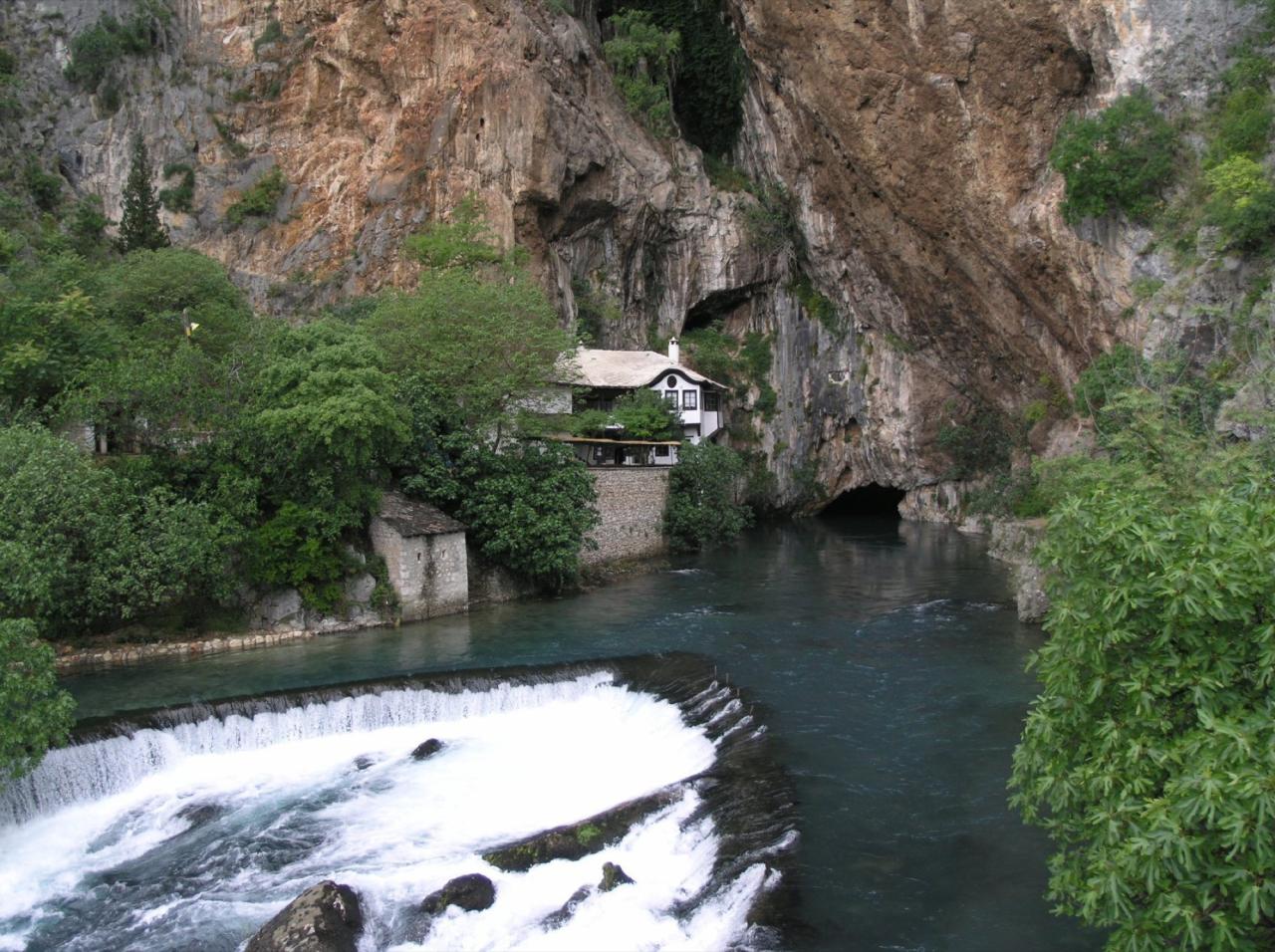 Blagaj Tekke beside the turquoise source of the Buna River under a limestone cliff