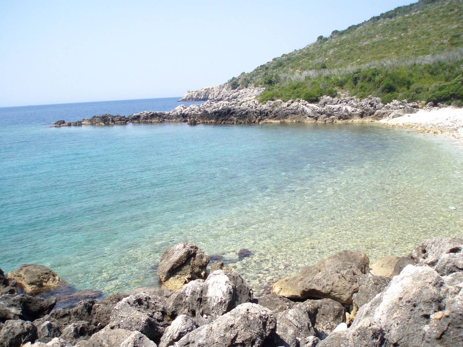 Clear water and rocks in a small coastal bay in the Himarë region